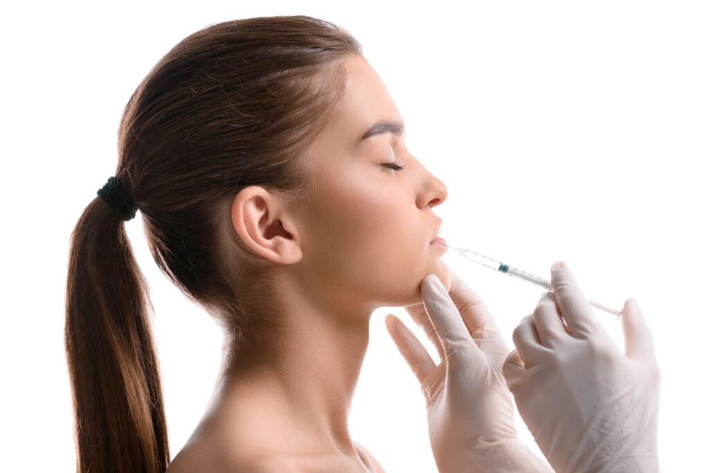 Portrait of attractive woman getting botox injection isolated on white